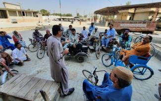 photo: people on wheelchair sitting in circle